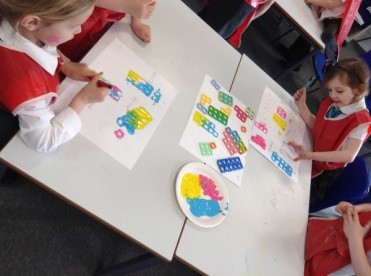 children at a table with shapes